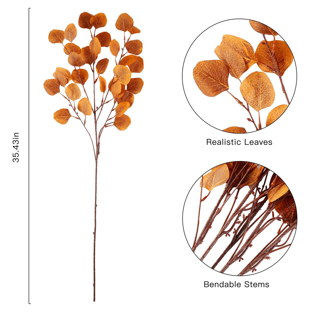 Künstliche Eukalyptusblätter in Orange arrangiert für eine herbstliche Tischdeko